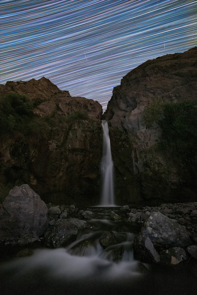 Waterfall under the stars in the sky